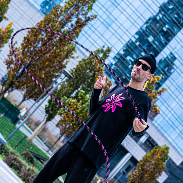 Good Flow practicing in Milan's Porta Nuova district with his California rope against an autumnal background, inviting you to join in