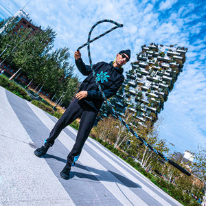 Phil practicing rope flow with his Good Flow Milano's Australiana rope, with Milan's Bosco Verticale in the background
